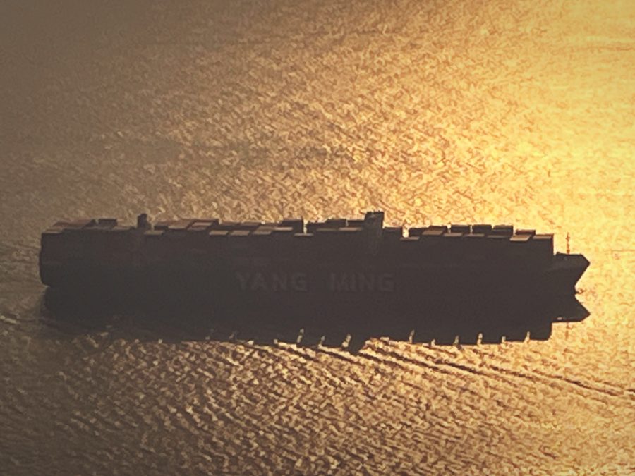 A container ship at sea at sunset